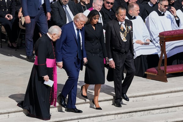 President Donald Trump and first lady Melania Trump, center, arrive for the funeral of Pope Francis in St. Peter's Square at the Vatican, Saturday, April 26, 2025. (AP Photo/Gregorio Borgia)