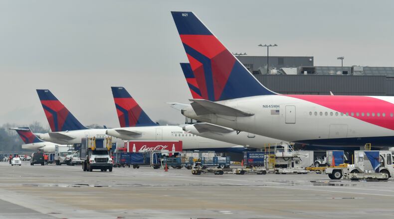 Delta Air Line planes at domestic gates at Hartsfield-Jackson International Airport in this February file photo. HYOSUB SHIN / HSHIN@AJC.COM