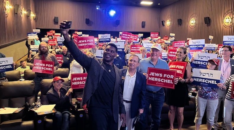 Republican Senate hopeful Herschel Walker takes a selfie at a Republican Jewish Coalition event on Aug. 21, 2022 in Sandy Springs.