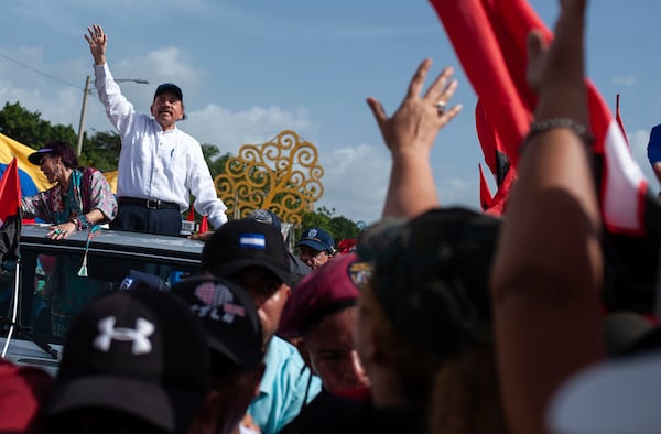 FILE - Nicaraguan President Daniel Ortega and his wife, Vice President Rosario Murillo, arrive at the Juan Pablo II plaza to celebrate the 39th anniversary of the Sandinista revolution, in Managua, Nicaragua, Thursday, July 19, 2018. (AP Photo/Cristobal Venegas, File)