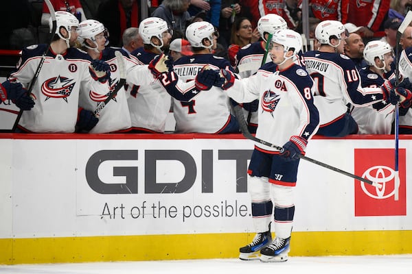 Columbus Blue Jackets defenseman Zach Werenski (8) celebrates his goal during the first period of an NHL hockey game against the Washington Capitals, Sunday, April 13, 2025, in Washington. (AP Photo/Nick Wass)