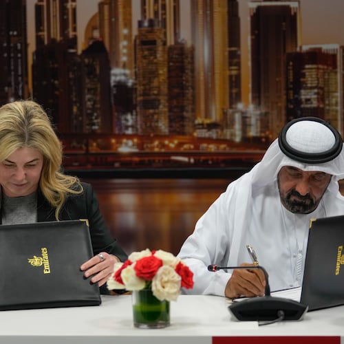 Stephanie Pope, President and CEO of Boeing Commercial Airplanes, left, and Sheikh Ahmed bin Saeed Al Maktoum, President, Dubai Civil Aviation Authority and Chairman of Emirates airlines, sign an agreement to order 65 additional Boeing 777X aircrafts, during a press conference on the opening day of the Dubai Air Show, United Arab Emirates, Monday, Nov. 17, 2025. (AP Photo/Altaf Qadri)