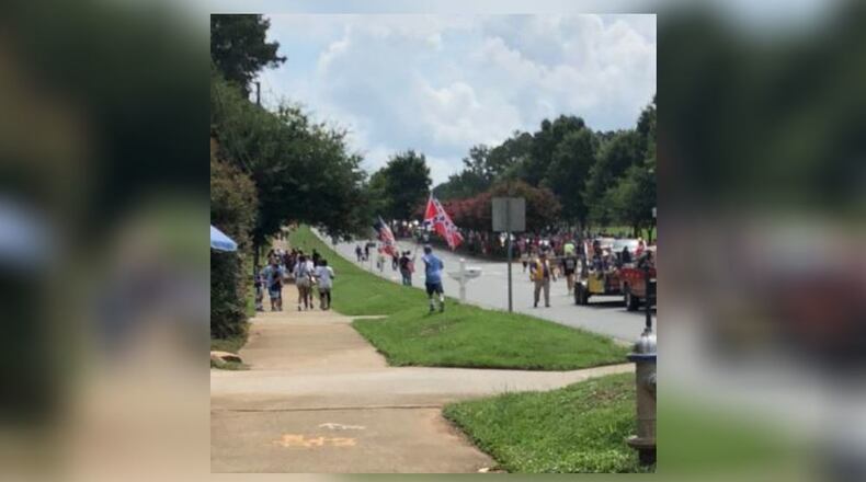 People displayed the Confederate flag along the route of the annual Old Soldiers Day Parade in Alpharetta. Participants in the parade could not display the flag.