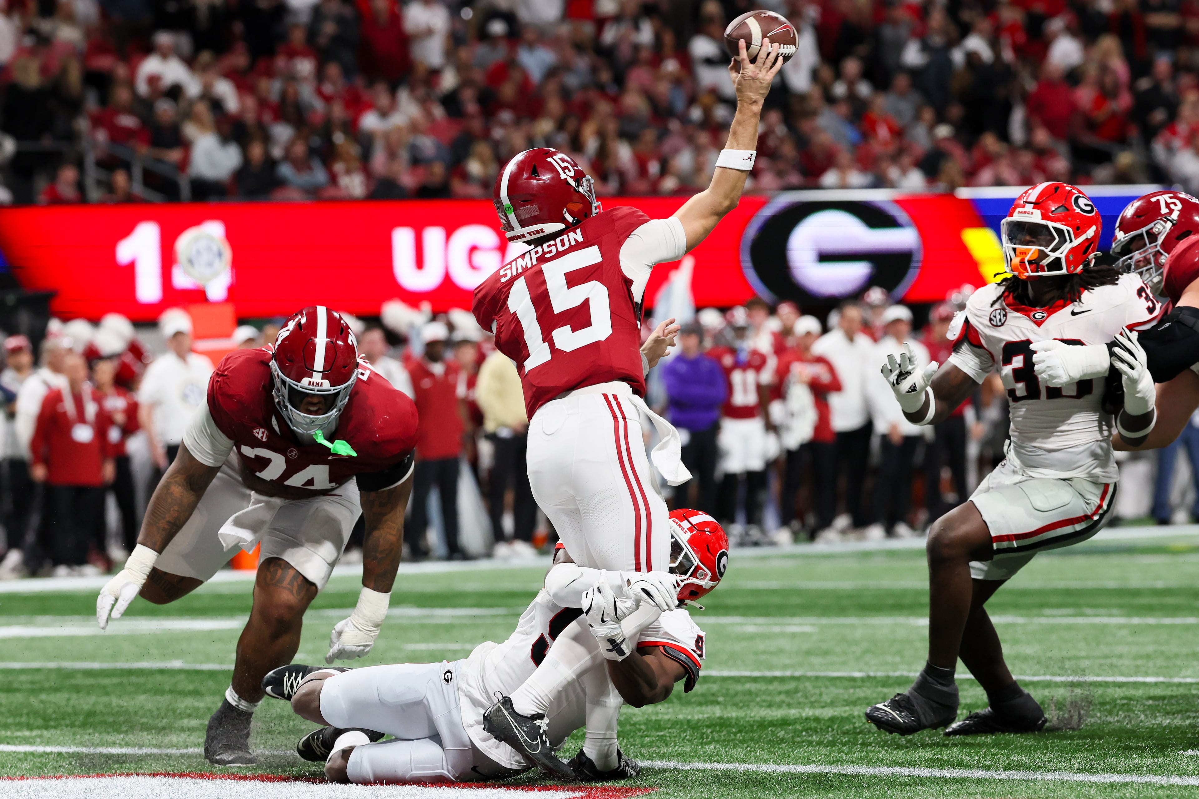 Alabama quarterback Ty Simpson (15) throws under pressure from the Georgia defense during the second quarter of the SEC Championship game at Mercedes-Benz Stadium, Saturday, Dec. 6, 2025, in Atlanta. (Jason Getz / AJC)