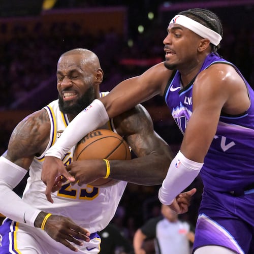 Los Angeles Lakers forward LeBron James, left, is fouled by Utah Jazz forward Blake Hinson (2) as he drives to the basket during the first half of an NBA basketball game Sunday, April 12, 2026, in Los Angeles. (AP Photo/Jayne Kamin-Oncea)