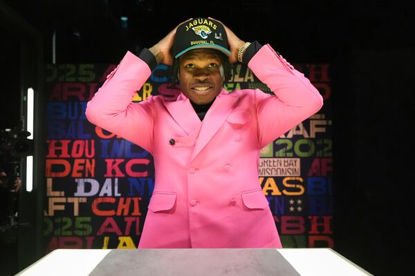 Colorado wide receiver Travis Hunter puts on a hat after being chosen by the Jacksonville Jaguars with the second overall pick during the first round of the NFL football draft, Thursday, April 24, 2025, in Green Bay, Wis. (AP Photo/Jeff Roberson)