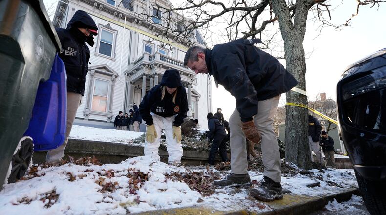 Members of the FBI Evidence Response Team search for evidence near the campus of Brown University, Monday, Dec. 15, 2025, in Providence, R.I. (AP Photo/Robert F. Bukaty)