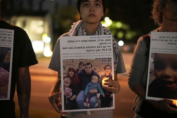 Israeli activists hold photos of Palestinian children killed during the Israel air and ground operation in the Gaza Strip, calling for an end to the war, during a protest in Tel Aviv, Israel, Saturday, May 24, 2025. (AP Photo/Leo Correa)