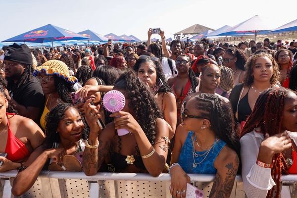 Attendees of Orange Crush in Tybee Island enjoy performances from artists and greek letter organizations on Saturday, April 19, 2025. (Natrice Miller/ AJC)