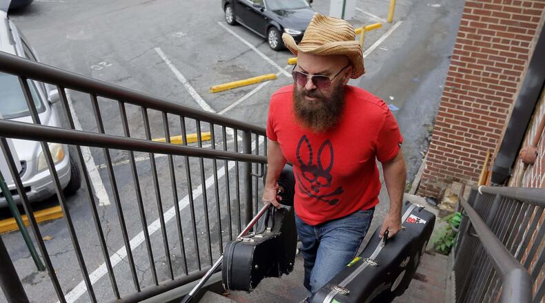 Singer/songwriter Angie Aparo carries in his equipment before his performance at Eddie’s Attic in Decatur in May.