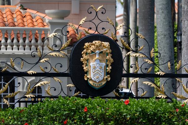 The family crest is displayed on the gate of the Trump International Golf Club, Friday, April 4, 2025, in West Palm Beach, Fla. (AP Photo/Alex Brandon)