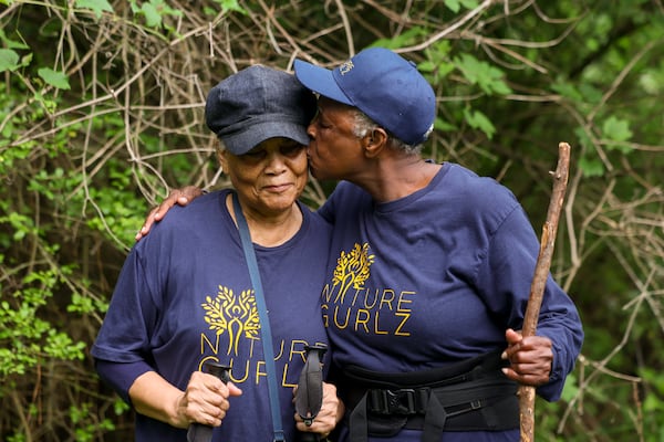 Nature Gurlz member Lillie Jackson (right) greets Sylvia Cook with a hug and a kiss on the cheek after making the halfway point of their walk along the trails at Cascade Springs Nature Preserve on April 22, 2025, in Atlanta. (Jason Getz/AJC)