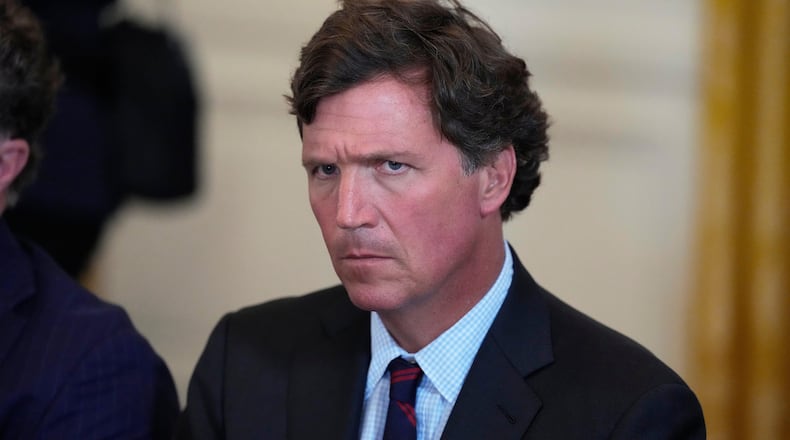 FILE - Tucker Carlson attends a meeting with President Donald Trump and oil executives in the East Room of the White House, Jan. 9, 2026, in Washington. (AP Photo/Alex Brandon, File)