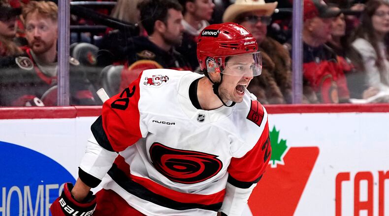 Carolina Hurricanes' Sebastian Aho (20) celebrates scoring an empty net goal against the Ottawa Senators in the third period in Game 4 of a first-round NHL Stanley Cup playoff hockey series, Saturday, April 25, 2026, in Ottawa, Ontario. (Justin Tang/The Canadian Press via AP)