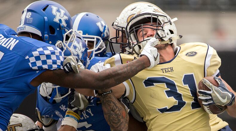 Georgia Tech running back Nate Cottrell, right, is tackled by Kentucky cornerback J.D. Harmon (11) on a kick return during the second half of the TaxSlayer Bowl NCAA college football game, Saturday, Dec. 31, 2016, in Jacksonville, Fla. Georgia Tech beat Kentucky 33-18. (AP Photo/Stephen B. Morton)