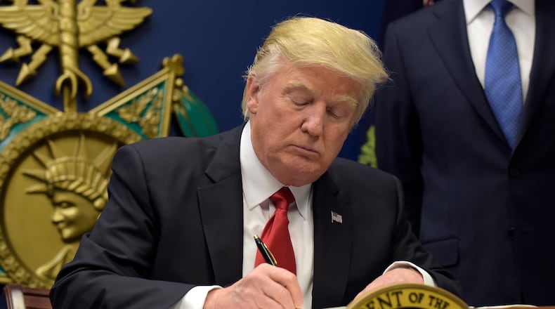 President Donald Trump signs an executive order on extreme vetting during an event at the Pentagon in Washington, Friday, Jan. 27, 2017. (AP Photo/Susan Walsh)