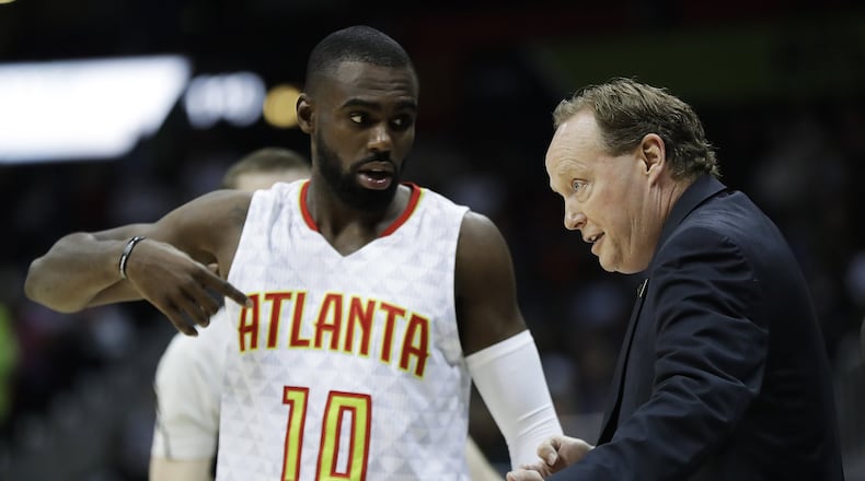 Atlanta Hawks head coach Mike Budenholzer, right, talks with Tim Hardaway Jr., in the second quarter of an NBA basketball game against the Toronto Raptors in Atlanta, Friday, March 10, 2017. (AP Photo/David Goldman)