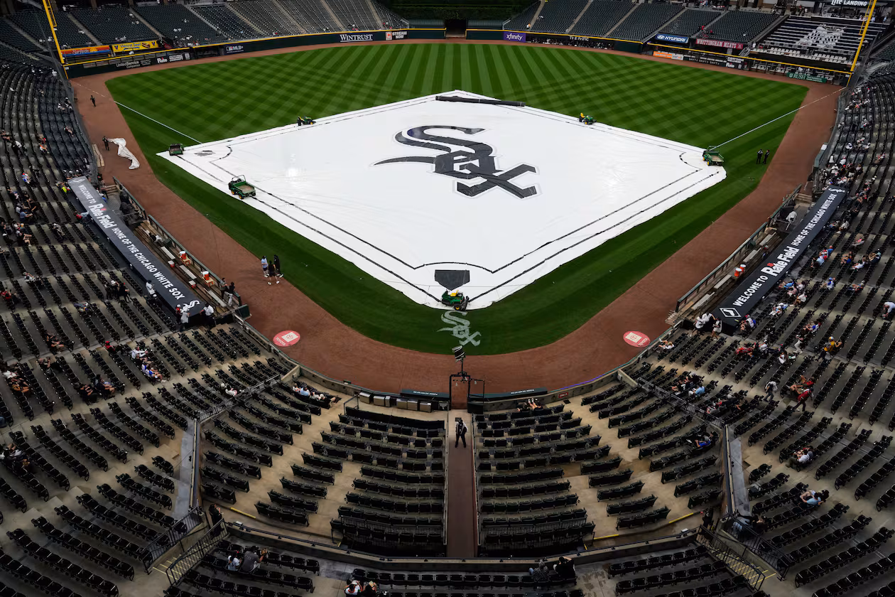 A tarp covers the infield during a rain delay before a baseball game between the Atlanta Braves and the Chicago White Sox in Chicago, Thursday, June 11, 2026. (AP Photo/Nam Y. Huh)