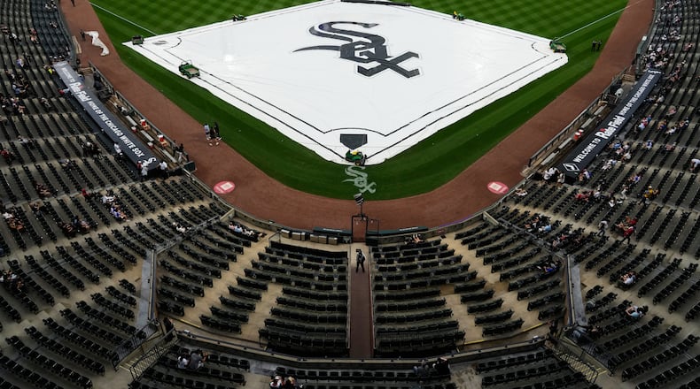 A tarp covers the infield during a rain delay before a baseball game between the Atlanta Braves and the Chicago White Sox in Chicago, Thursday, June 11, 2026. (AP Photo/Nam Y. Huh)