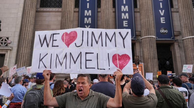 FILE - Oscar Villanueva holds a sign outside El Capitan Entertainment Centre, where the late-night show "Jimmy Kimmel Live!" is staged, Sept. 18, 2025, in Los Angeles. (AP Photo/Jae C. Hong, File)