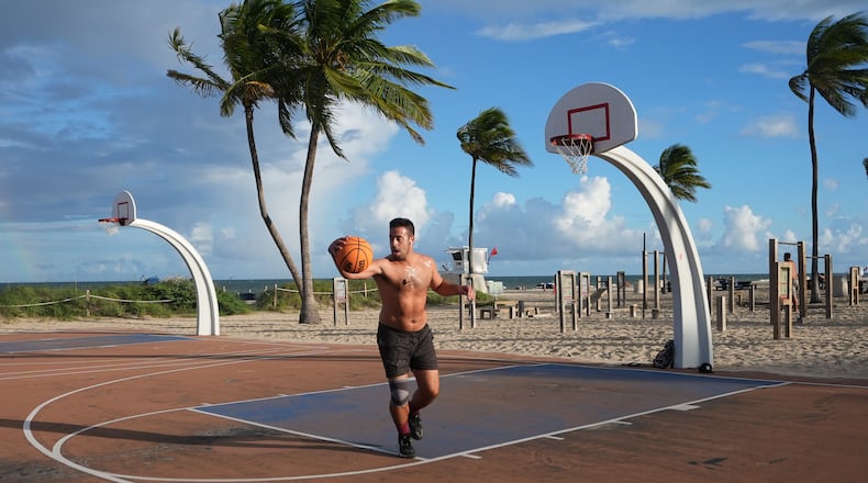 Gonzalo de Leon plays basketball at Fort Lauderdale Beach Park, the site of proposed pickleball courts as part of a new luxury development, Oct. 8, 2025, in Fort Lauderdale, Fla. (AP Photo/Lynne Sladky)
