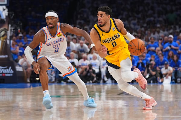 Indiana Pacers guard Tyrese Haliburton (0) drives past Oklahoma City Thunder guard Shai Gilgeous-Alexander (2) during the second half of Game 5 of the NBA Finals basketball series, Monday, June 16, 2025, in Oklahoma City. (AP Photo/Kyle Phillips)