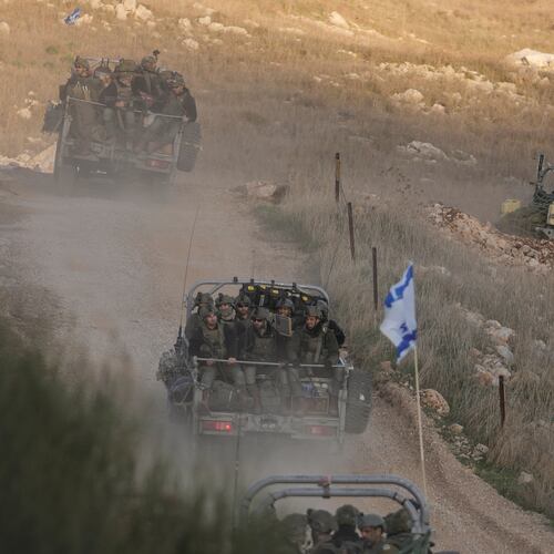 FILE - Israeli soldiers cross the security fence moving towards the so-called Alpha Line that separates the Israeli-annexed Golan Heights from Syria, in the town of Majdal Shams, Dec. 15, 2024. (AP Photo/Matias Delacroix, File)