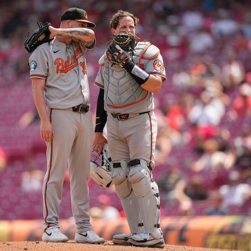 Baltimore Orioles pitcher Kyle Bradish, left, and catcher Adley Rutschman, right, talk on the mound during the eighth inning of a baseball game against the Cincinnati Reds in Cincinnati, Sunday, July 5, 2026. (AP Photo/Carolyn Kaster)