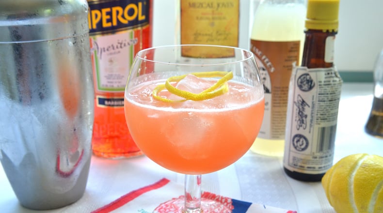 Staplehouse mixologist Shyretha Bolton calls this mezcal-Aperol drink The Oaxaca Flacka Flame - a play on Oaxaca, the Mexican state known for the smokey maguey agave spirit, and Atlanta rapper Waka Flocka Flame. Food styling by Wendell Brock. (Chris Hunt/Special)