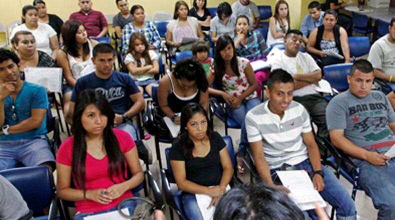 In this Thursday, Sept. 20, 2012 photo , Charlene Gomez leads an orientation seminar for illegal immigrants, to determine if they qualify for temporary work permits, at the Coalition for Humane Immigrant Rights of Los Angeles (CHIRLA), in Los Angeles. Schools and consulates have been flooded with requests for documents since President Barack Obamaís administration said many young illegal immigrants may be eligible for two-year renewable work permits. The new policy has left schools and consulates scrambling for quick fixes ranging from new online forms, reassigned workers and extended hours. (AP Photo/Reed Saxon)