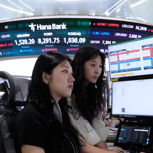 Currency traders watch monitors at the foreign exchange dealing room of the Hana Bank headquarters in Seoul, South Korea, Friday, June 12, 2026. (AP Photo/Ahn Young-joon)