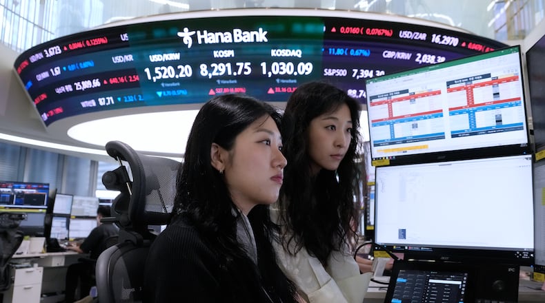 Currency traders watch monitors at the foreign exchange dealing room of the Hana Bank headquarters in Seoul, South Korea, Friday, June 12, 2026. (AP Photo/Ahn Young-joon)