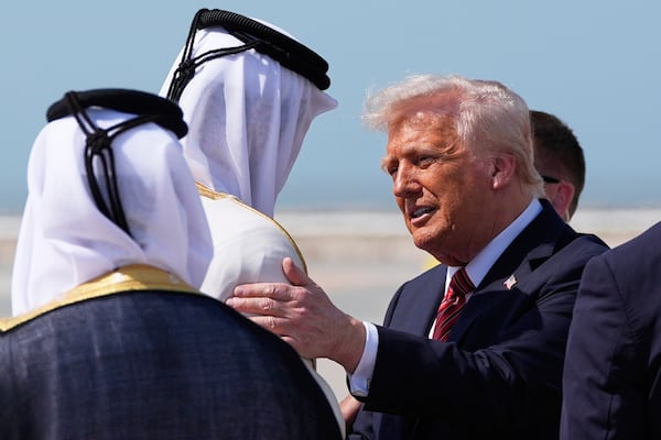 President Donald Trump is greeted by Qatar officials as he arrives at Hamad International Airport in Doha, Qatar, on Wednesday.