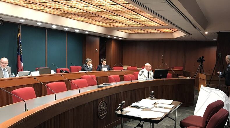 Decatur City Attorney Bryan Downs, at the podium to the right, appeared before the Georgia Immigration Enforcement Review Board on Monday with Police Chief Mike Booker, seated to Downs’ right, and defended the city against a complaint filed by Lt. Gov. Casey Cagle.