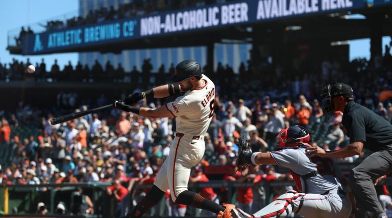 San Francisco Giants' Bryce Eldridge hits a grand slam in front of Washington Nationals catcher Keibert Ruiz during the ninth inning of a baseball game in San Francisco, Wednesday, June 10, 2026. (AP Photo/Jed Jacobsohn)