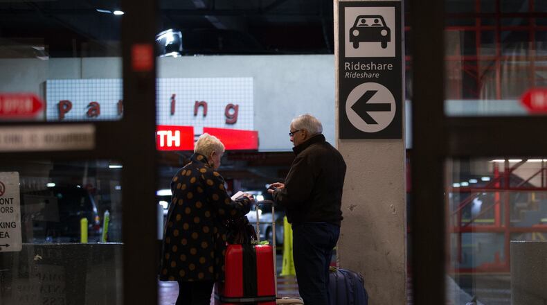 Travelers wait at the designated rideshare area at Hartsfield-Jackson Atlanta International Airport. BRANDEN CAMP/SPECIAL