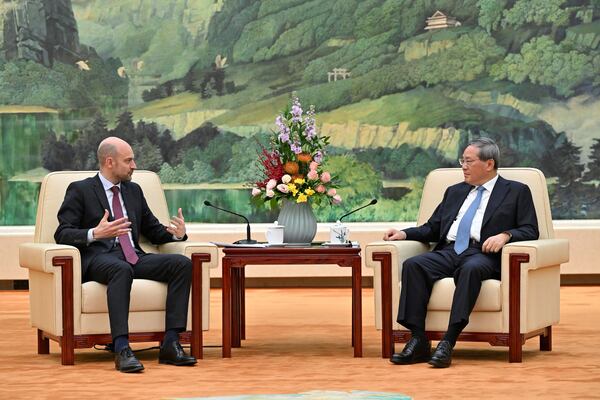 China's Premier Li Qiang, right, and French Foreign Minister Jean-Noel Barrot meet at the Great Hall of the People in Beijing Thursday, March 27, 2025. (Adek Berry/Pool Photo via AP)