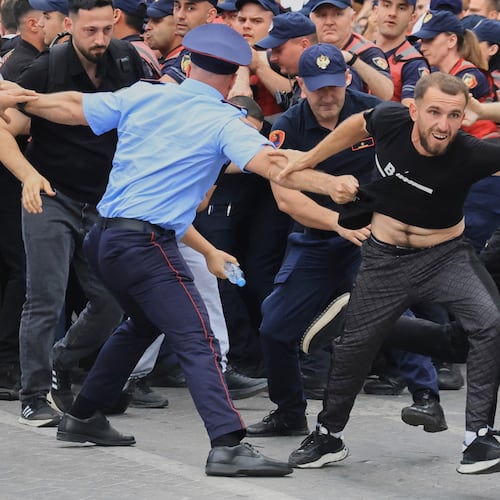 Protesters scuffle with police officers blocking a street during a demonstration in Tirana, Albania, Wednesday, June 3, 2026, opposing a luxury coastal development project linked to Jared Kushner and Ivanka Trump over concerns about environmental impacts and transparency.(AP Photo/Hameraldi Agolli)