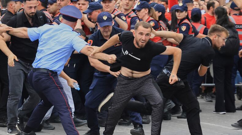 Protesters scuffle with police officers blocking a street during a demonstration in Tirana, Albania, Wednesday, June 3, 2026, opposing a luxury coastal development project linked to Jared Kushner and Ivanka Trump over concerns about environmental impacts and transparency.(AP Photo/Hameraldi Agolli)