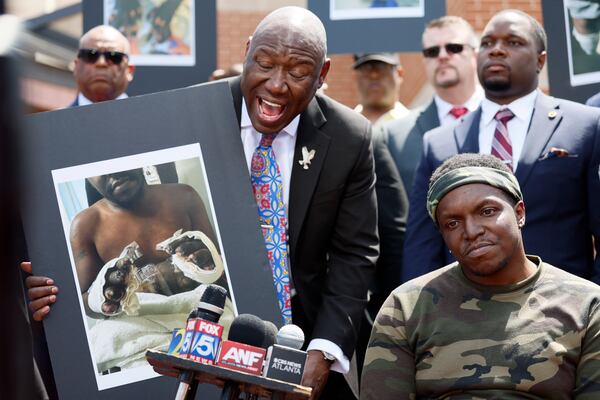 Attorney Ben Crump speaks to the media as his client, Rashaad Muhammad, listens outside the Fulton County Jail on Wednesday, April 29, 2026. Muhammad and his attorney share his account of alleged medical negligence and deliberate indifference he claims to have experienced while in custody, leading to multiple amputations. (Miguel Martinez/AJC)