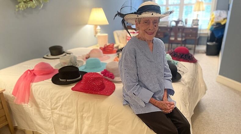 Betty Ewing, of Signal Mountain, has worn a hat to church every Sunday for 60 years. Here, she poses with part of her hat collection Wednesday. (Photo Courtesy of Mark Kennedy)