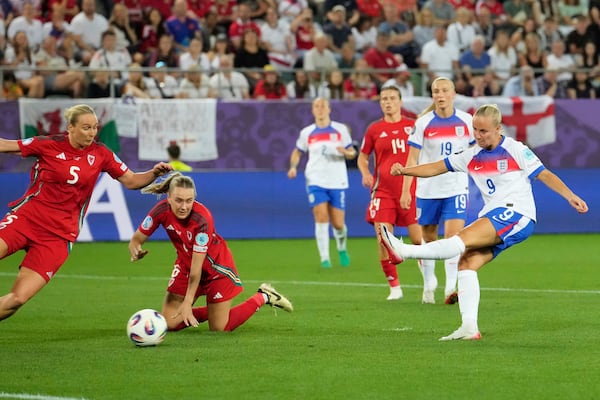 England's Beth Mead, right, shoots to score her sides fifth goal during the Women's Euro 2025, group D, soccer match between England and Wales at Arena St. Gallen in St. Gallen, Switzerland, Sunday, July 13, 2025. (AP Photo/Martin Meissner)