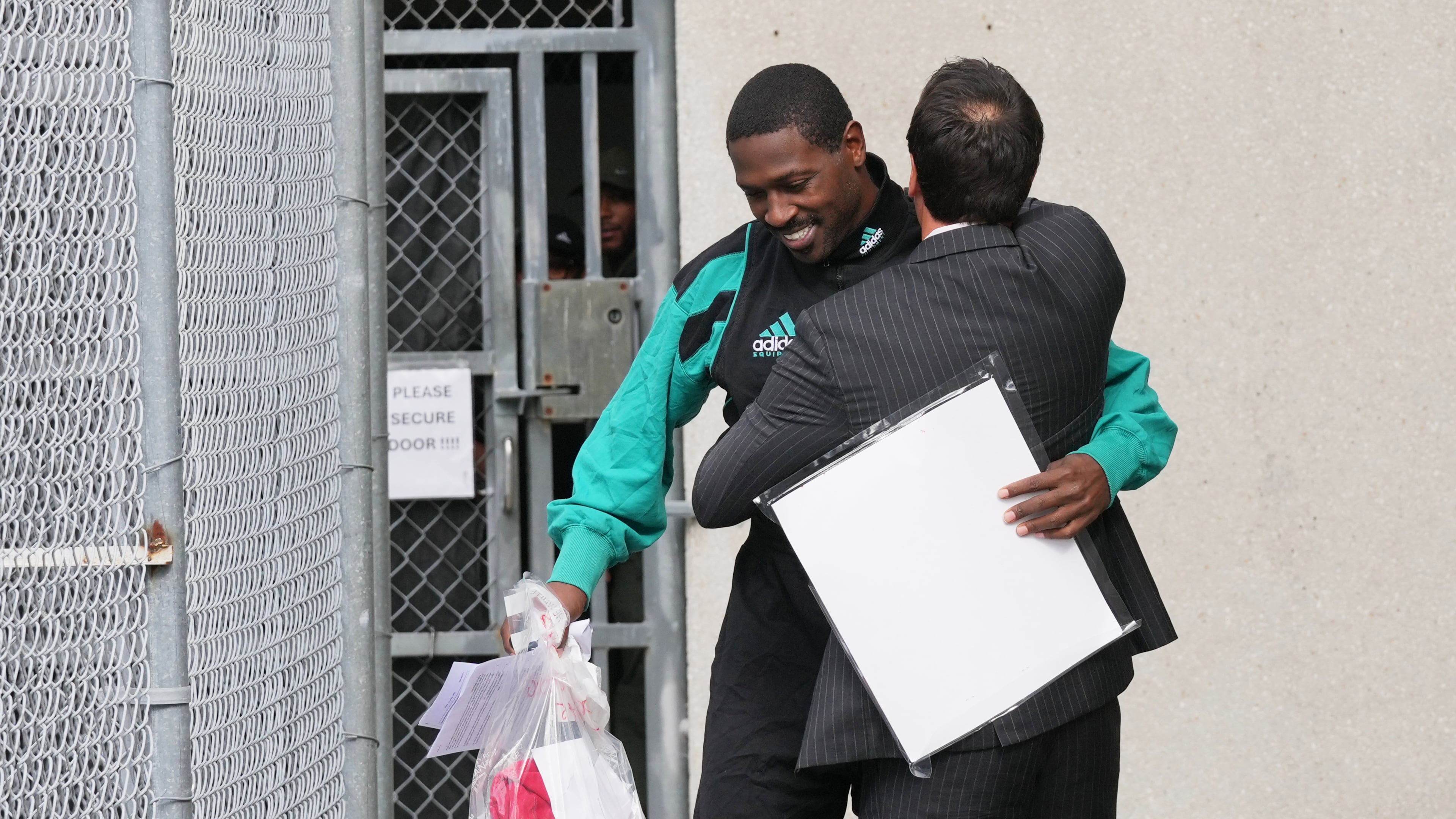 Former NFL star wide receiver Antonio Brown, left, greets his attorney Mark Russell Eiglarsh, right, after being released from the Turner Guilford Knight Correctional Center, Thursday, Nov. 13, 2025, in Miami. (AP Photo/Lynne Sladky)