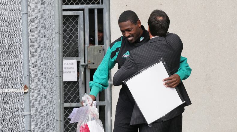 Former NFL star wide receiver Antonio Brown, left, greets his attorney Mark Russell Eiglarsh, right, after being released from the Turner Guilford Knight Correctional Center, Thursday, Nov. 13, 2025, in Miami. (AP Photo/Lynne Sladky)