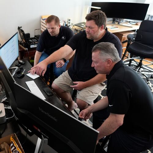 Andrew Leeper, left, Will Minkoff and Tom Johnstone, right, of Nashville Severe Weather, look over weather data Monday, April 20, 2026, in Nashville, Tenn. (AP Photo/George Walker IV)