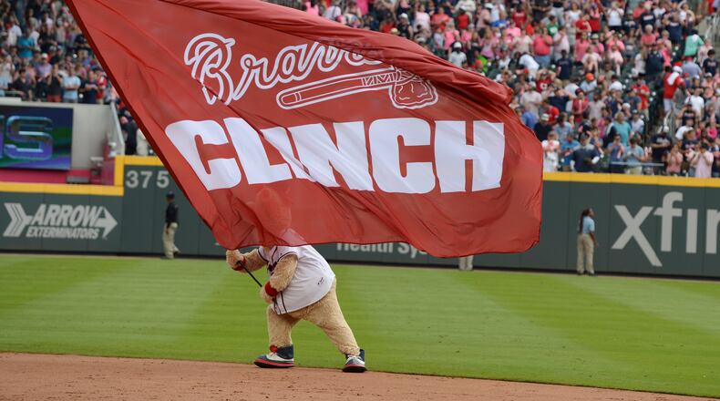 Mascot Blooper waves a flag after the Braves clinched the NL East title with a win over the Phillies at SunTrust Park.