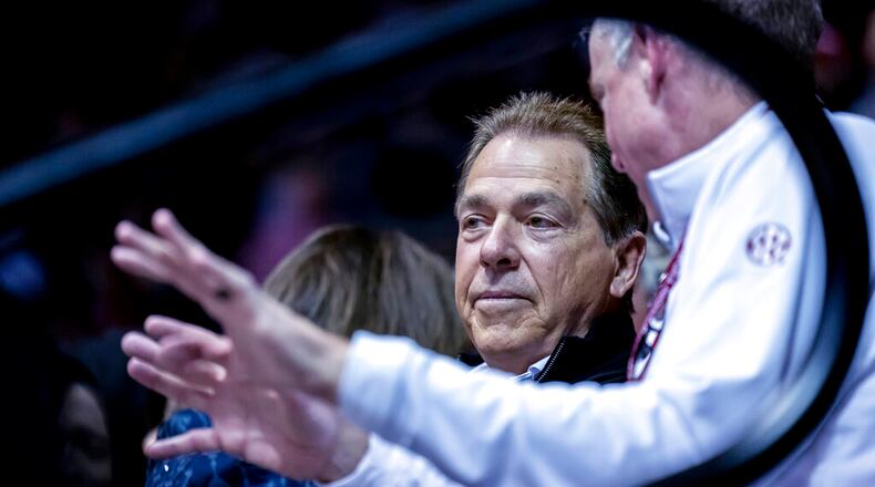 Alabama football coach Nick Saban talks with athletic director Greg Byrne, right, while watching Alabama play against Georgia during the first half of an NCAA college basketball game Saturday, Feb. 18, 2023, in Tuscaloosa, Ala. (AP Photo/Vasha Hunt)