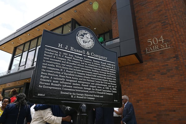 The Georgia Historical Society marker commemorating H.J. Russell & Co.’s original headquarters, reads: "Graduating in 1952 from Tuskegee Institute, Herman Russell (1930-2014) founded the H.J. Russell Plastering Company in Atlanta, which became H.J. Russell & Company. The company and its subsidiaries are among the nation’s most successful and diversified African-American business enterprises involved in construction, real estate, airport concessions, banking, beverage distribution, and media. With clients that included government, small businesses, and Fortune 500 companies, H.J. Russell & Company helped build modern-day Atlanta with the construction of Hartsfield-Jackson Atlanta International Airport, Mercedes Benz-Stadium, State Farm Arena, and the National Center for Civil and Human Rights. A nationally recognized entrepreneur and philanthropist, and one of Atlanta’s most influential leaders, Russell stepped down as CEO in 2003. Herman Russell’s influence continues through the Russell Innovation Center for Entrepreneurs, Concessions International, and H.J. Russell & Company.

Erected by the Georgia Historical Society and H.J. Russell & Company." (Hyosub Shin/AJC)