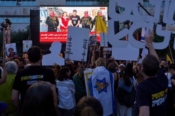 People watch a live broadcast of Israeli-American soldier Edan Alexander as he is released from Hamas captivity in Gaza, at a plaza known as the hostages square in Tel Aviv, Monday, May 12, 2025. Alexander was abducted during the Hamas-led attack on his base on October 7, 2023. (AP Photo/Oded Balilty)