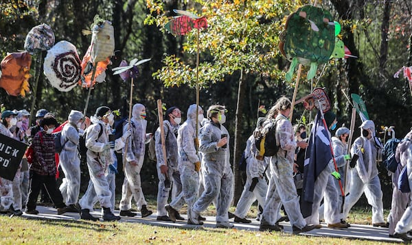 Protesters head through a neighborhood toward the site of the Atlanta Public Safety Training Center ahead of a showdown with police on Monday, Nov. 13, 2023. (John Spink/AJC)